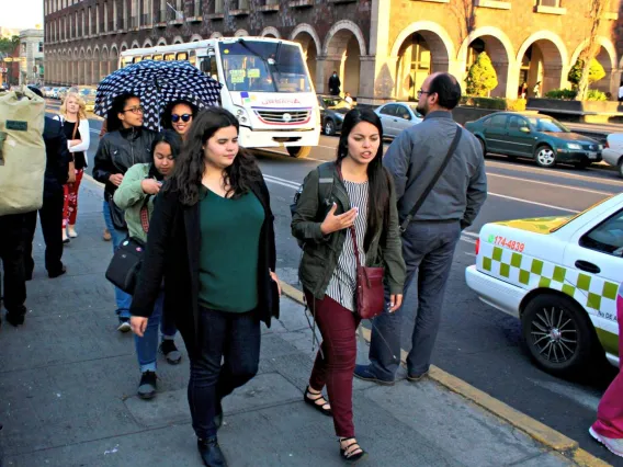 two women walking down a street talking to each other