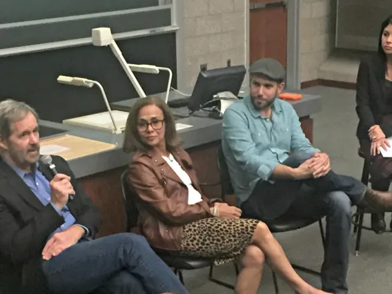 four people on a speaking panel answering audience questions