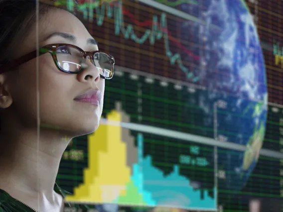 woman in glasses looking at digital overlay of the world