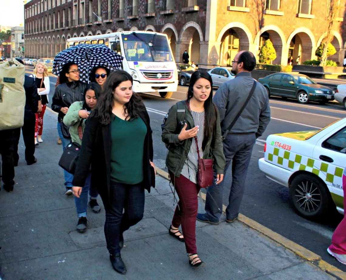 two women walking down a street talking to each other