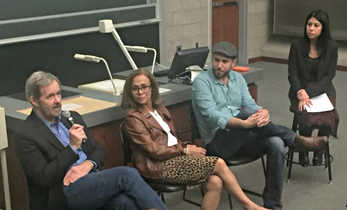 four people on a speaking panel answering audience questions