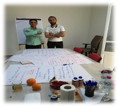 two men standing behind a table indoors