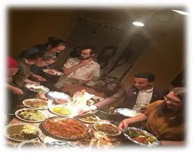 students enjoying a large Tunisian dinner together