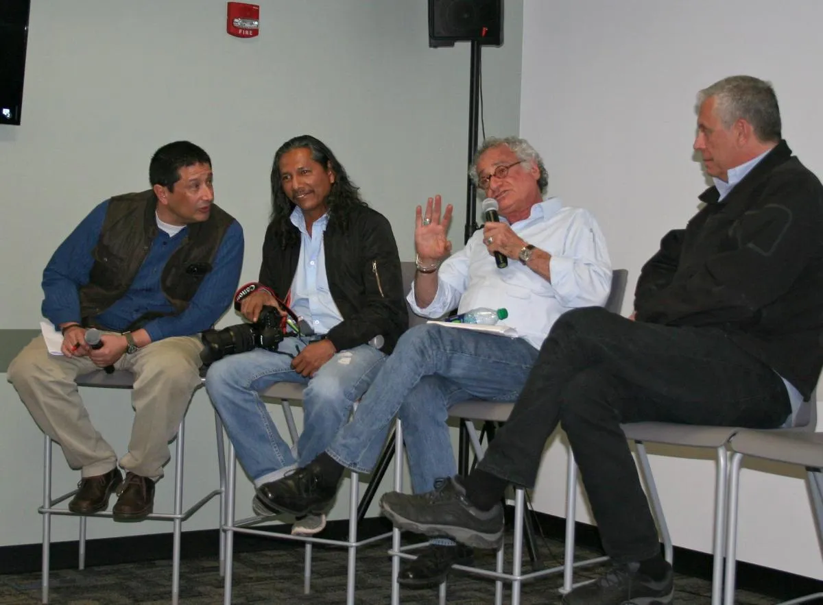 panel of speakers sitting in classroom answering questions from audience