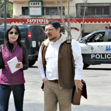 woman speaking to man while standing in street