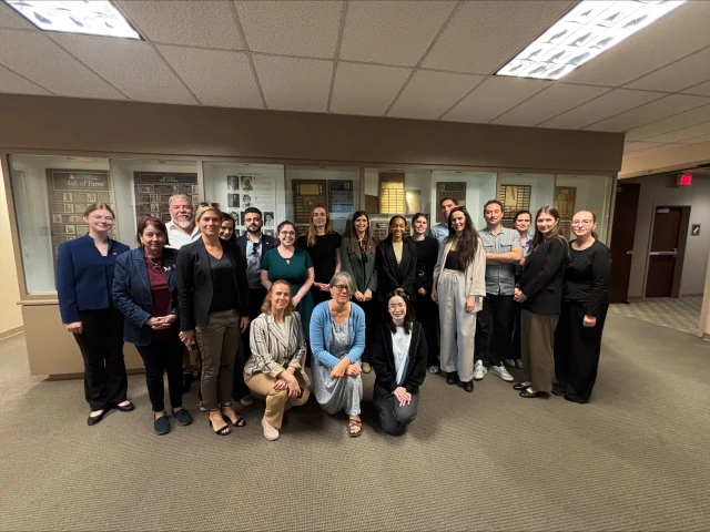 Visitors stand in the halls of the School of Journalism 